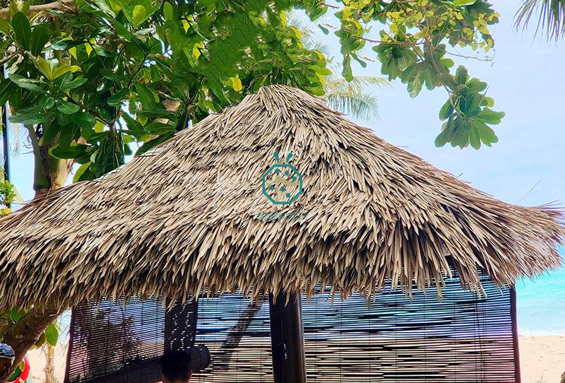 Beachfront tiki bars for tourist with artificial nylon thatch roof covering Beachfront tiki bars for tourist with artificial nylon thatch roof covering